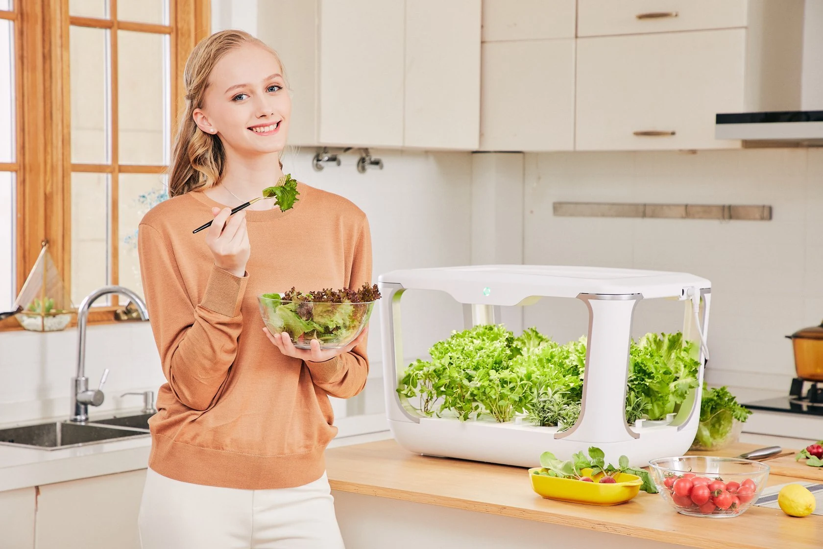 Enjoying fresh greens beside an indoorGreens countertop hydroponic garden